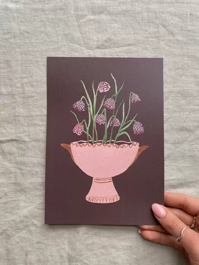 print with fritillaria also known as snakes head flowers in a pink vase.