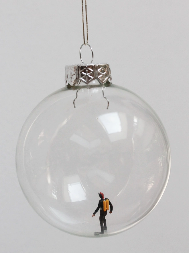 Miniature figure of a diver in a glass Christmas bauble 