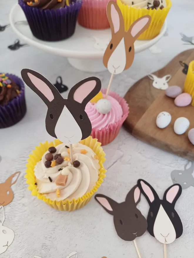 Close view of dark brown and white rabbit cupcake topper displayed in cupcake