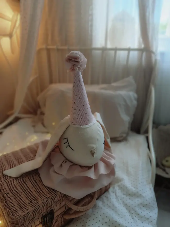 Rabbit Head Wall Mount, a cotton rabbit head wall decoration in a child's bedroom accompanied by other bedroom accessories. 