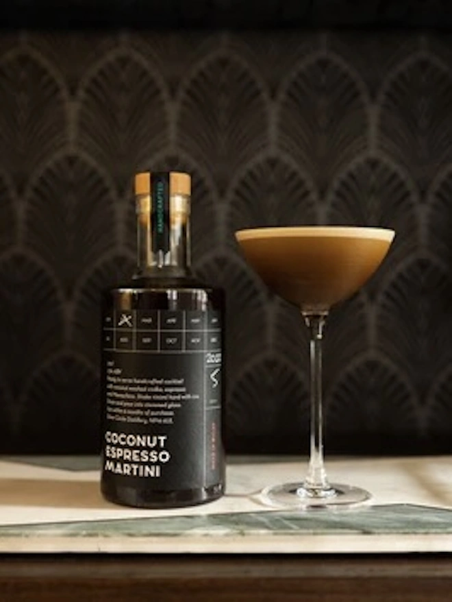 The Holiday Essentials Bundle (Pack Of 7), espresso martini and bottle of spirits on a table. 