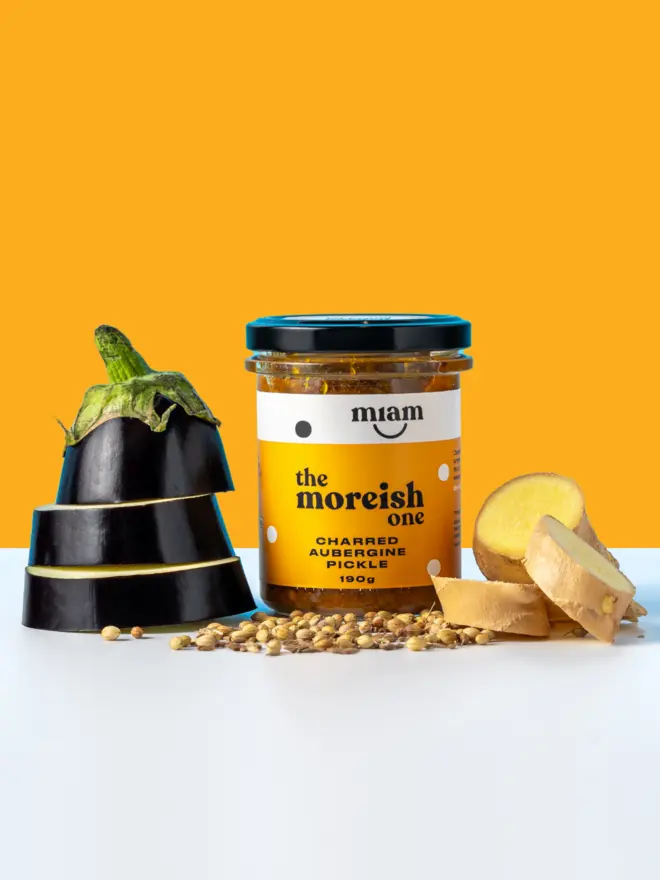 jar of aubergine pickle with slices of aubergine and spices and ginger