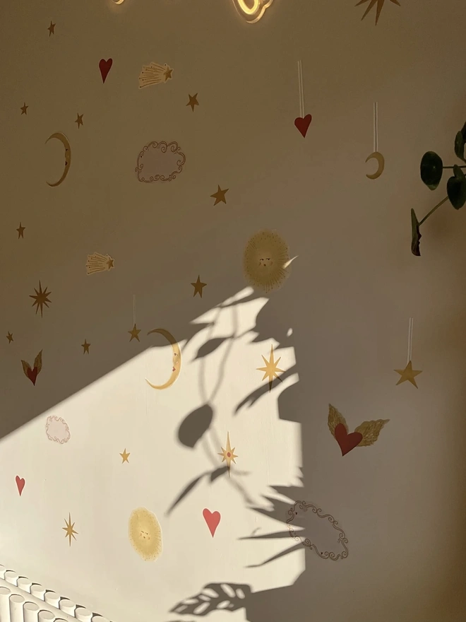 Celestial Dream Fabric Wall Stickers, a wall decorated with colourful wall stickers. 