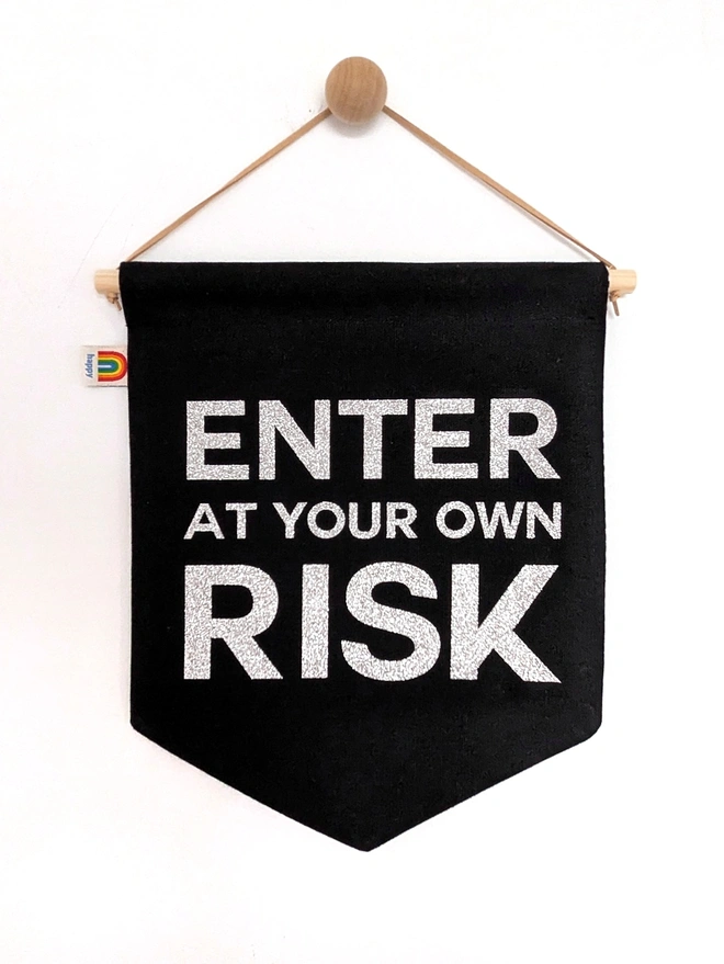 Non personalised option if "ENTE AT YOUR OWN RISK" banner. In black with silver glitter text. 