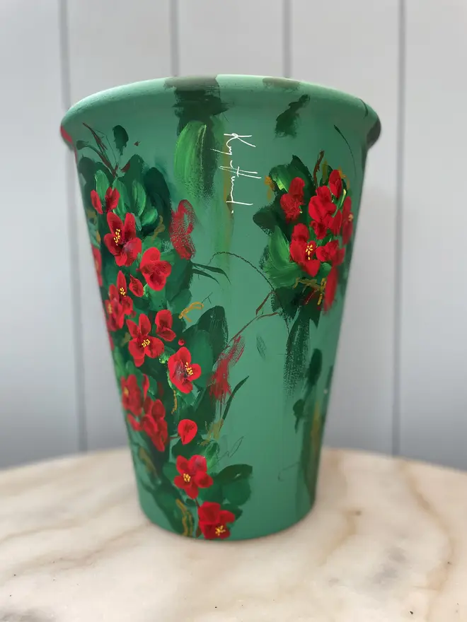 Unique hand-painted terracotta pot featuring quince on a deep rich green background