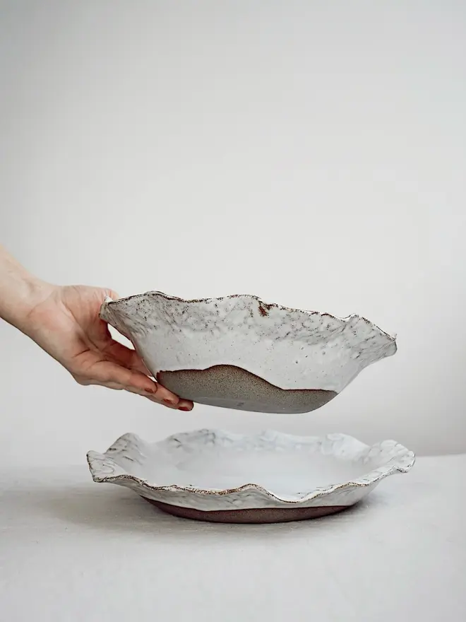 Dapple Stoneware Pasta Bowl, stacked on top of each other placed on a table cloth. 