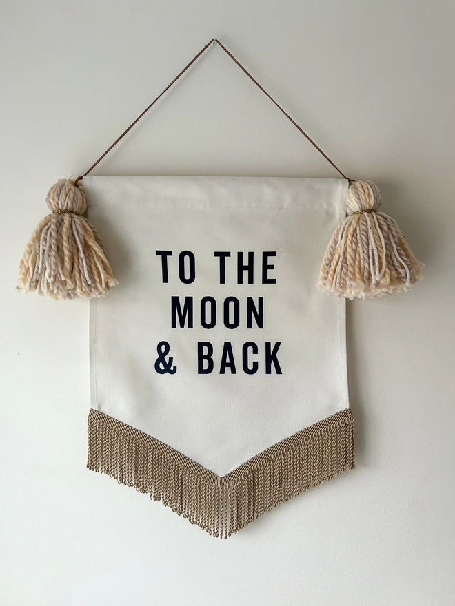 To the Moon and Back fabric printed banner with neutral caramel tassels and gold trim