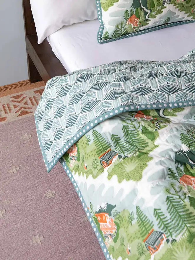 Manali Flatweave Rug, a colourful rug sitting in a bedroom. It is accompanied by other colourful furniture. 