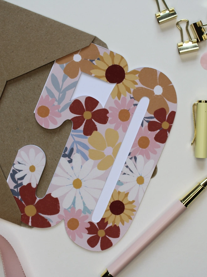 floral 50th birthday card. card shaped like 50 decorated with colourful flowers.