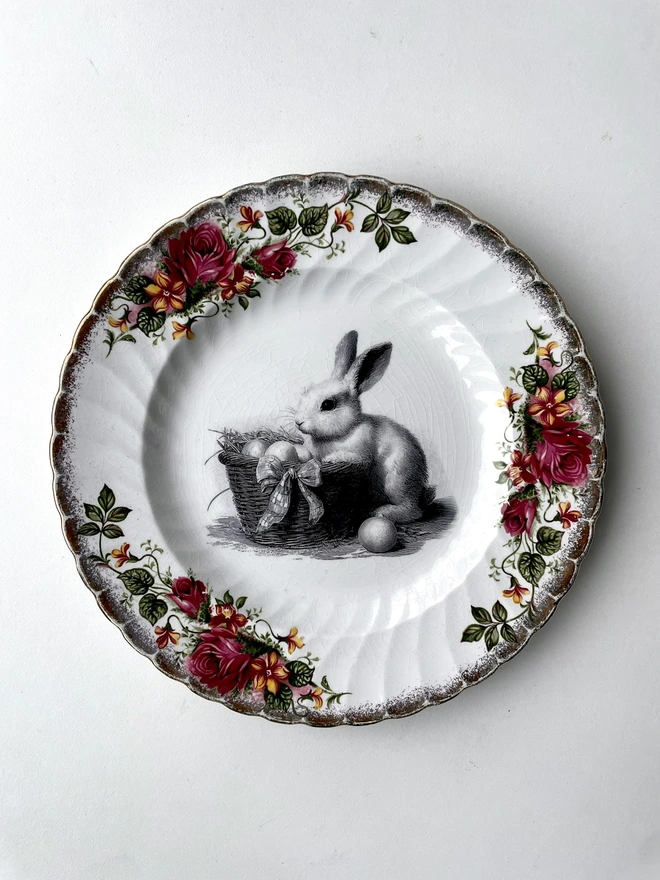 a vintage plate with decorative ornate borders, in the centre i have printed a vintage black and white illustration of the Easter Bunny rabbit