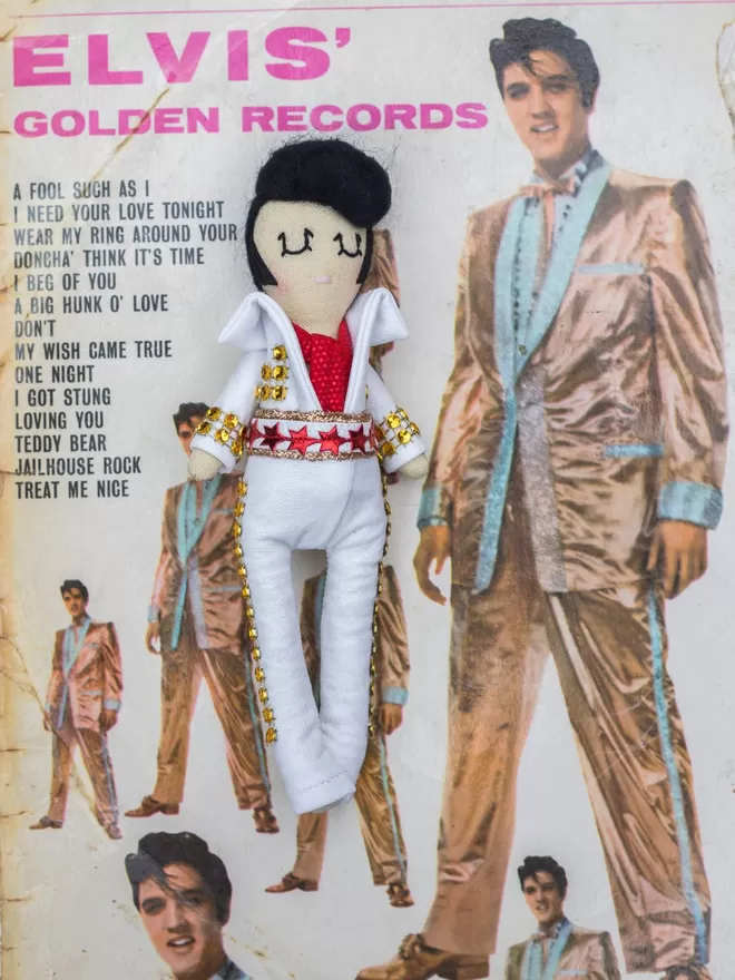 Elvis Presley Doll seen on his album cover.