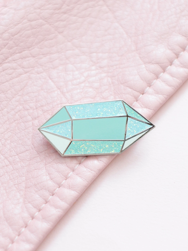 aquamarine enamel pink badge on pink leather jacket