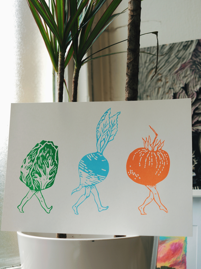 A white landscape page, featuring a fun design with a green lettuce with legs, a blue radish with legs, and an orange tomato with legs.