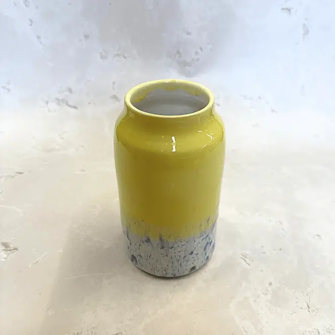 Shoreline Large Vase, a colourful vase placed on a stone surface in front of a plain backdrop. 