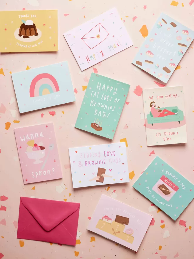 Colourful gift card designs and envelopes against a terrazzo background