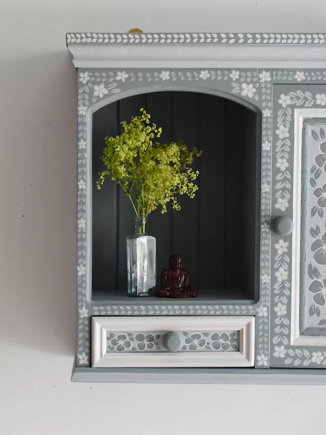 blue hand painted folk art cupboard with folky floral detailing