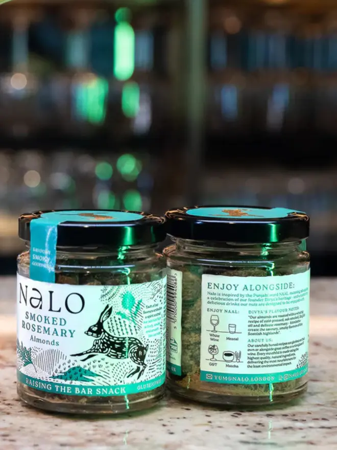 Two Smoked Rosemary Almonds Jars, displayed against a kitchen background. 