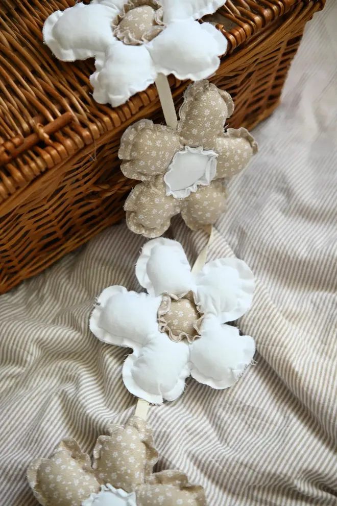 Daisy Flower Garland Decoration, a hanging colourful daisy flower garland sitting in a child's bedroom. 