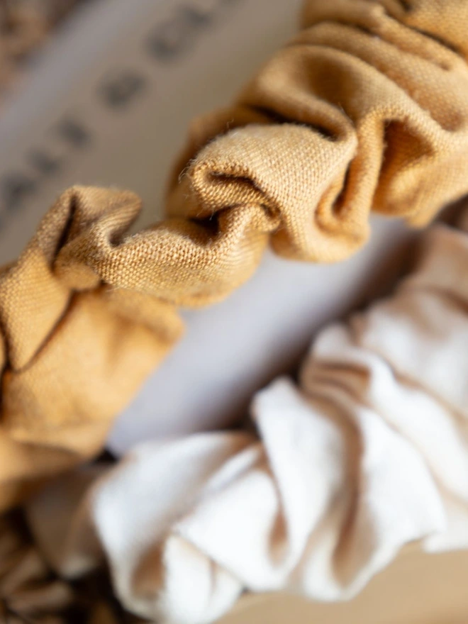 cotton linen scrunchies in colour oat and ochre.