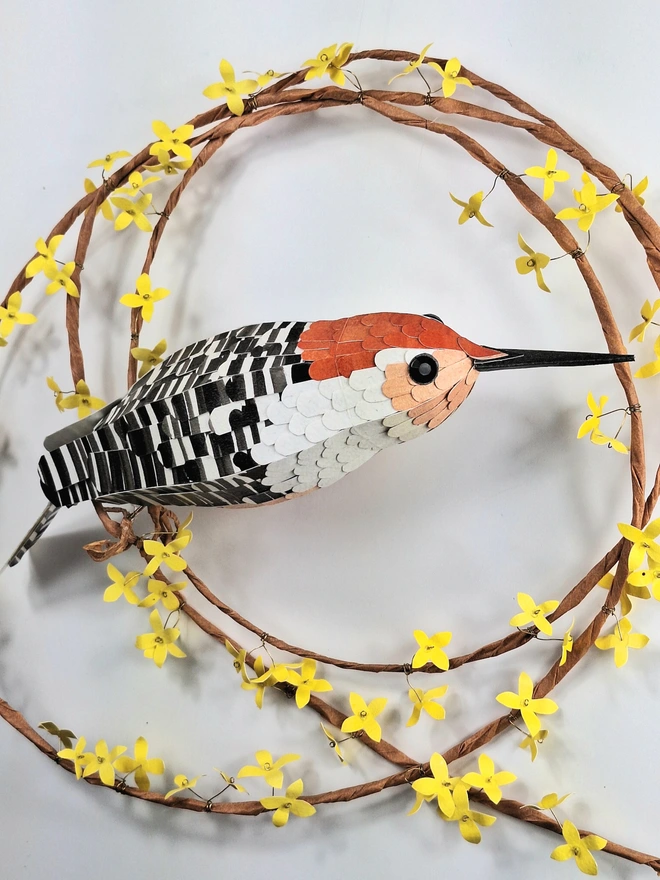 handmade wall art featuring an orange bellied woodpecker on a spring wreath of yellow forsythia flowers