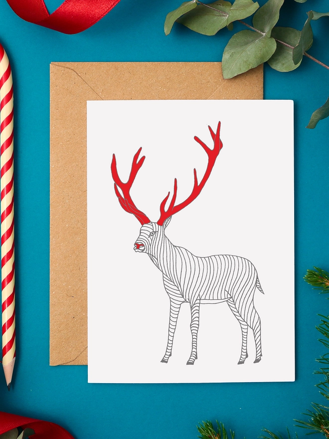 Traditional Christmas Card Featuring a Stag With Red Antlers