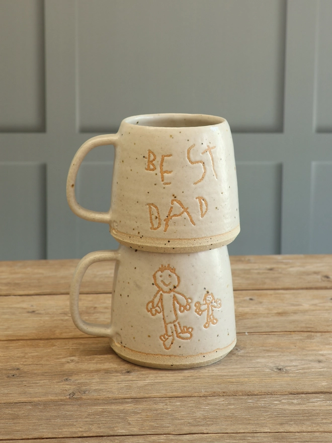 Handmade Stoneware Ceramic Mug glazed in which with a baby's handprint on the front 