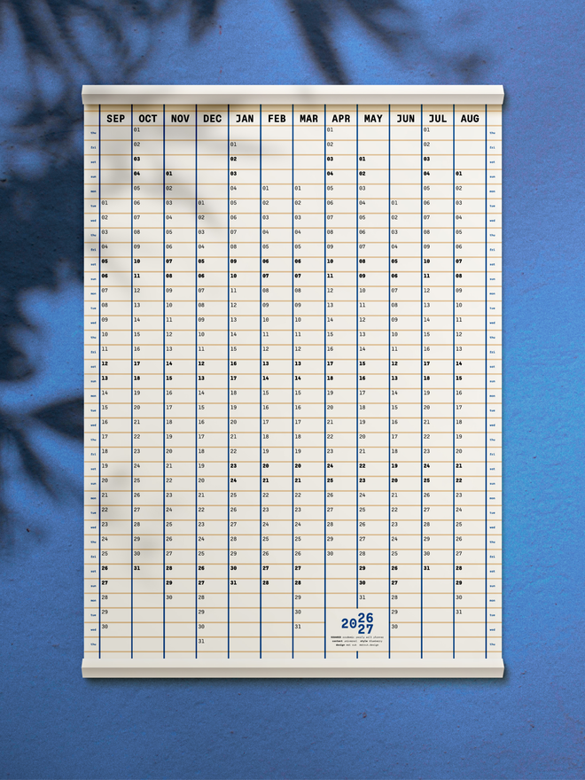 A planner for the 2026-27 academic year on blue wall