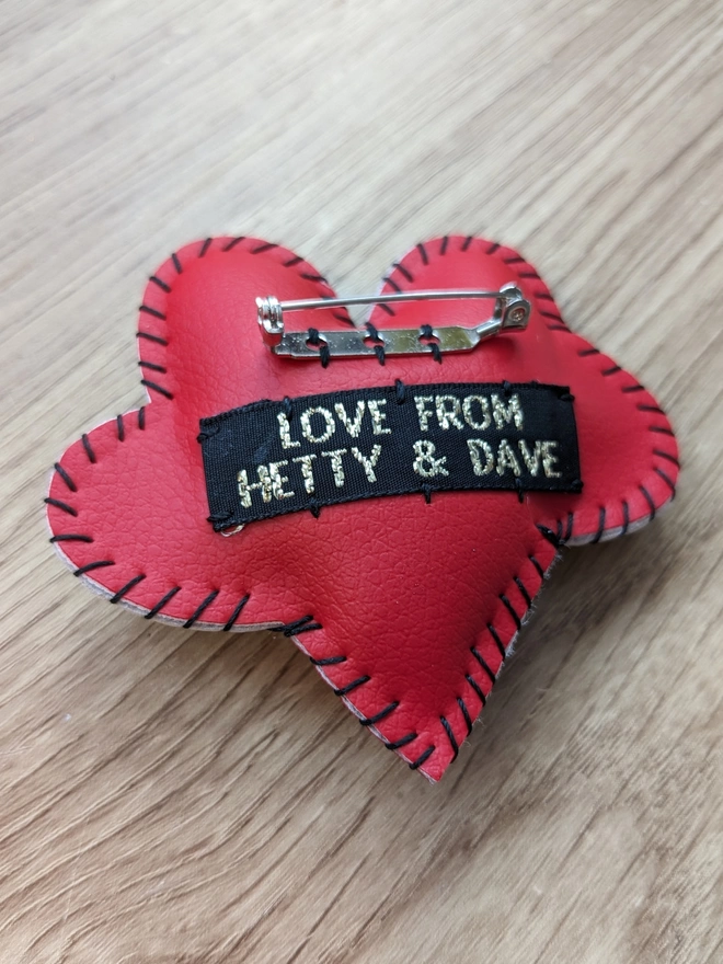 Reverse of Hetty and Dave red leatherette heart brooch