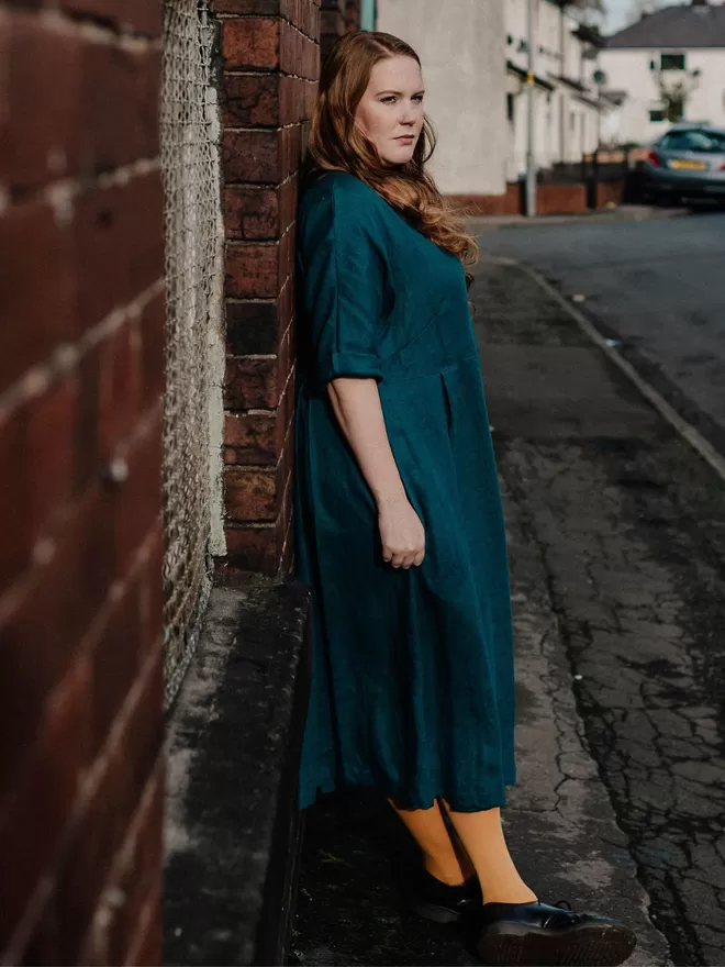 pleated linen dress in teal side view