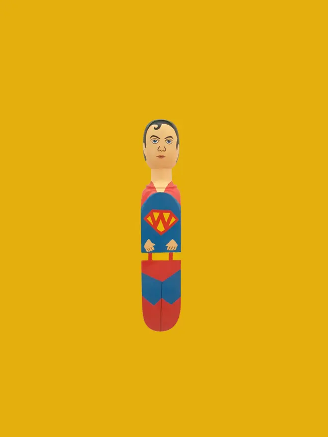 Wooden Door Stopper (Super Wedgie), a colourful wooden door stop on a yellow background