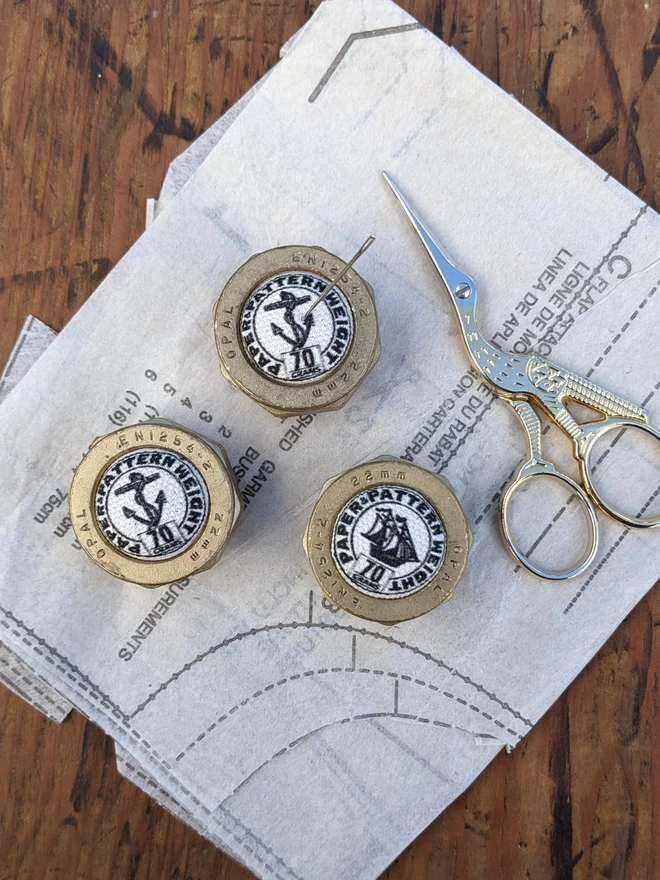 Set of 3 Anchors Aweigh Pattern Weights lying on sewing pattern with scissors