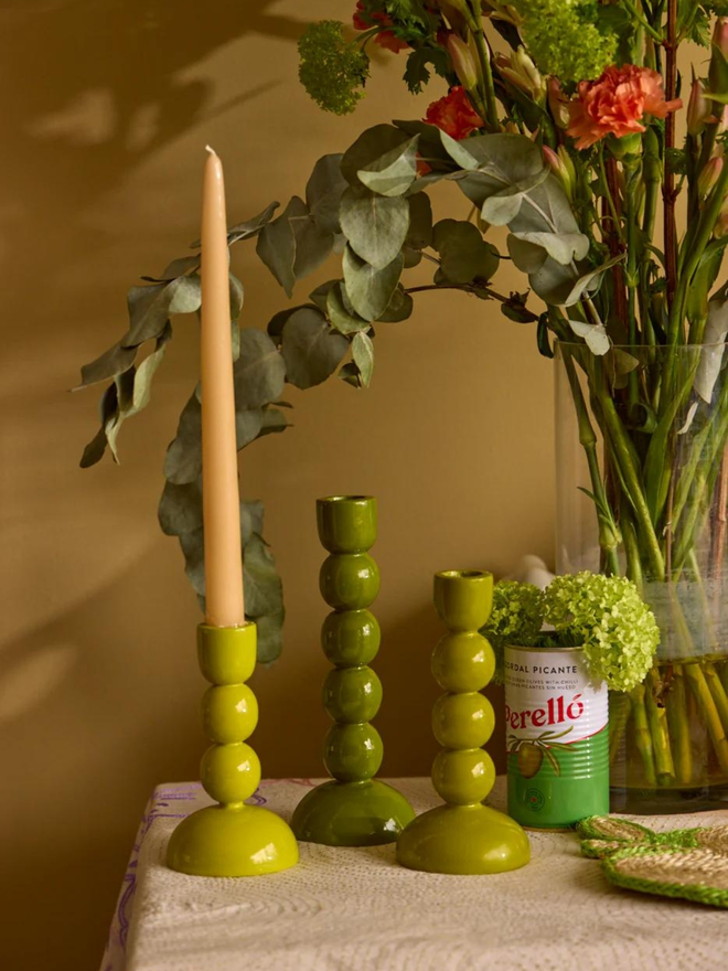 olive green wooden candlestick holder lifestyle shot