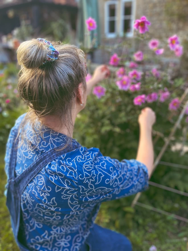 model wearing liberty vanessa roe hair scrunchie in the garden