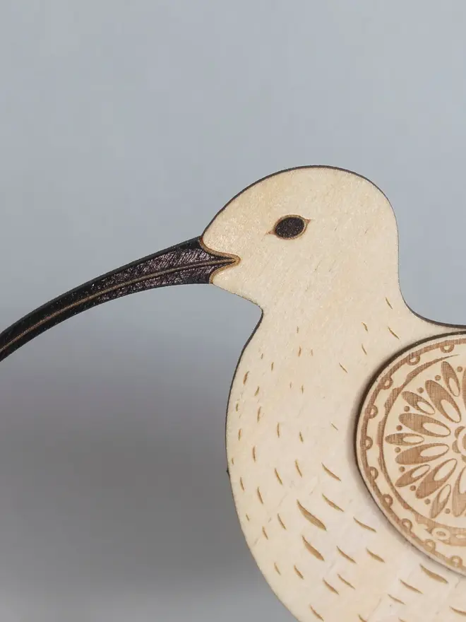 Standing Wooden Curlew, wooden bird decoration standing on a platform. 