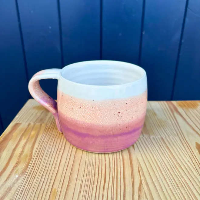 Ice Cream Sundae Large Round Mug, a colourful mug sitting on a wooden surface against a navy blue backdrop. 