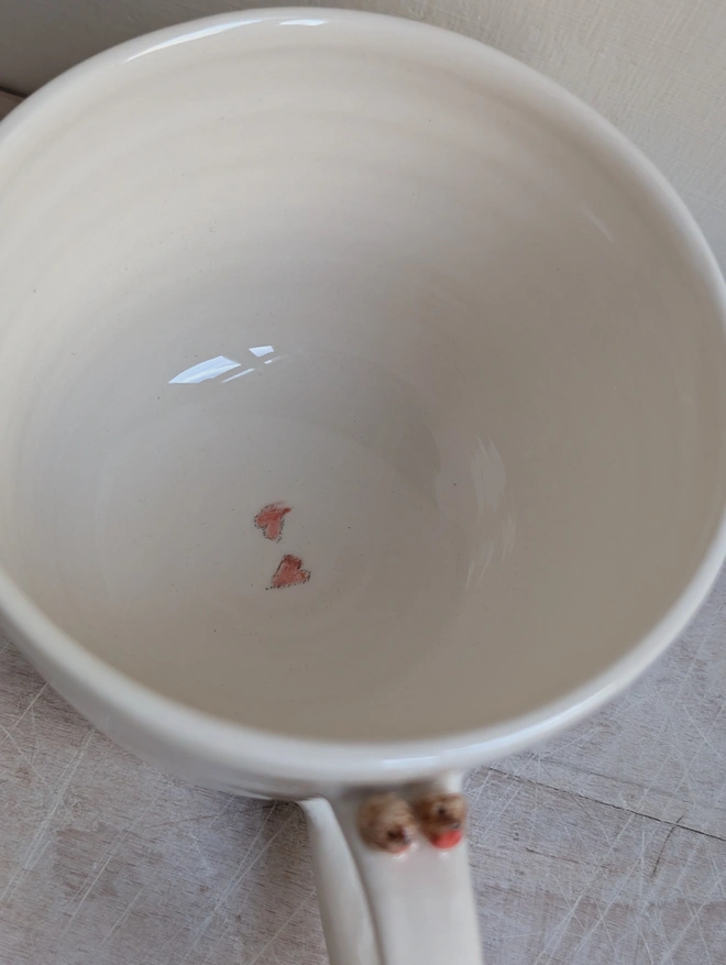 robin couple mug with a tiny pair of robin red breast birds on the cup handle and small bird prints on the white cup and hand painted hearts inside