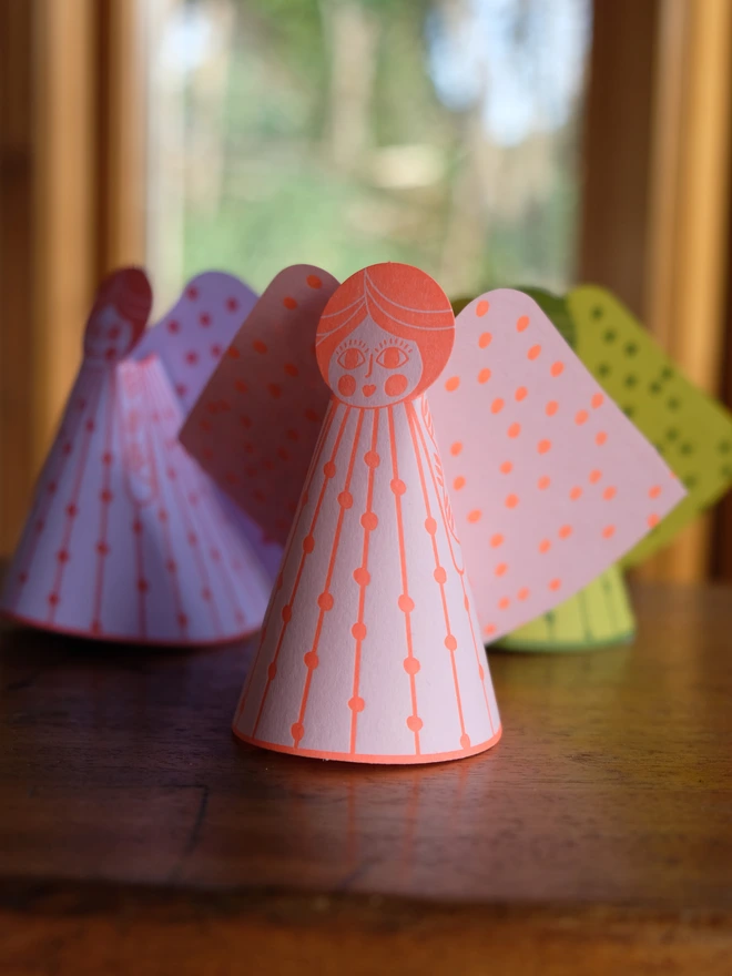 Set of three pop-out Christmas angels. Orange, purple and green. 