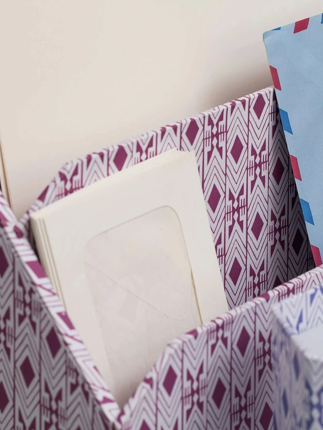 Tijan Letter Rack, a colourful patterned letter rack sitting in a study. 