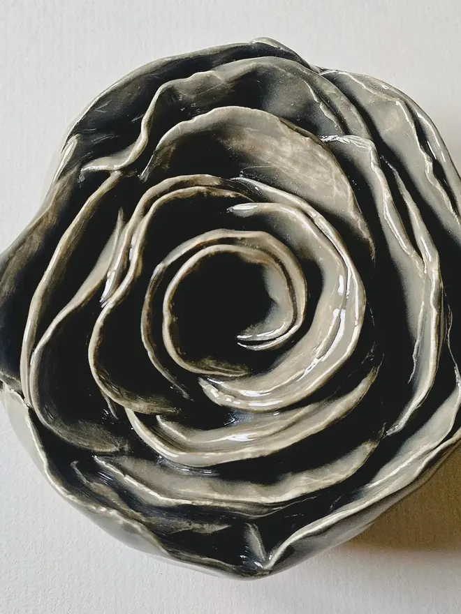 Handmade ceramic rose sculpture with a gray/greenglossy glaze, crafted in 3D and designed to hang on a wall
