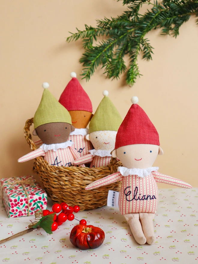 handmade elf dolls in stripe top and red or green hat with a name embroidered, in four different skin tones. 