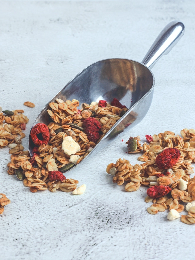 Happy Heads 'Raspberry & White Chocolate' granola in a scoop