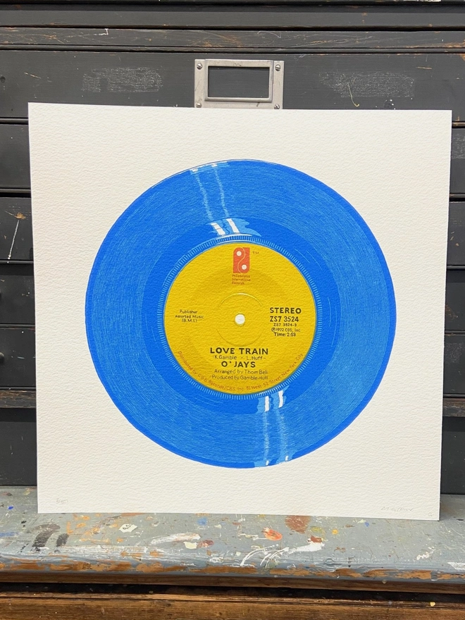 Love Train Blue Vinyl Screen Print leaning on a shelf
