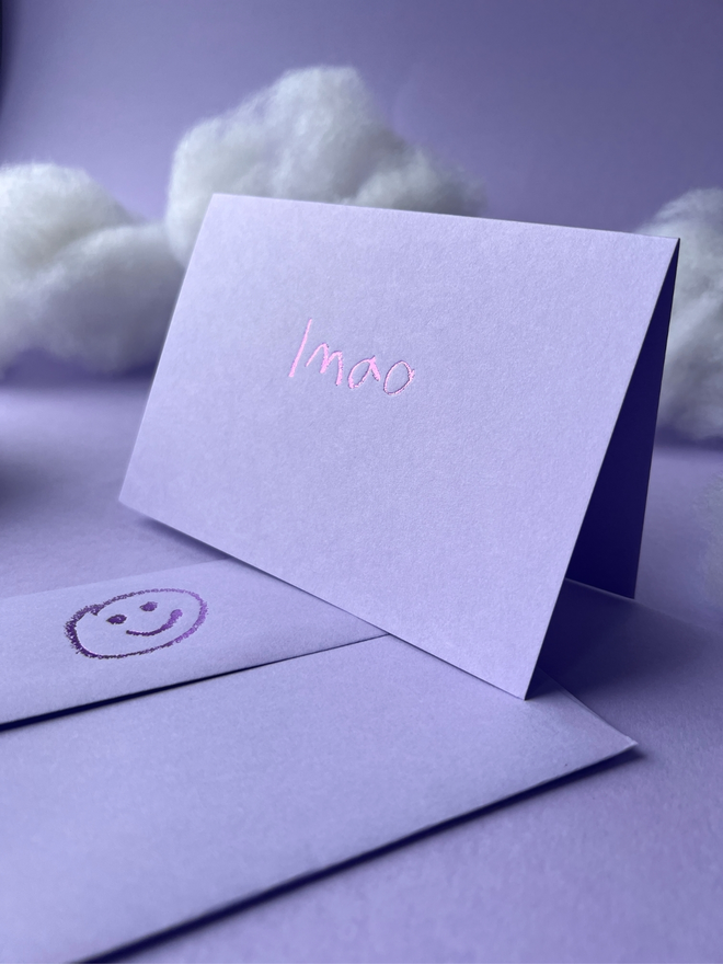 lavender coloured card with lmao  short for 'laugh my ass off' hand foiled in kids hand writing