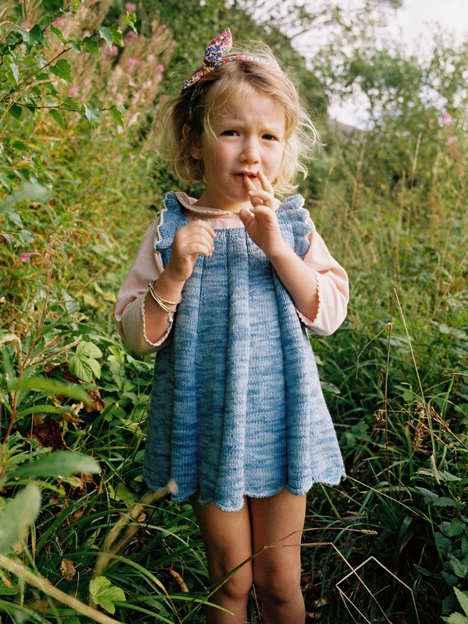 Little girl in her Hairband and blue dress outside