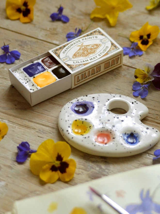 Lilian May handmade watercolour paints and ceramic mini palette with sketchbook and flowers.