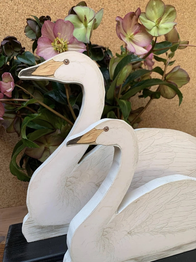 A pair of decorative, cutout swans