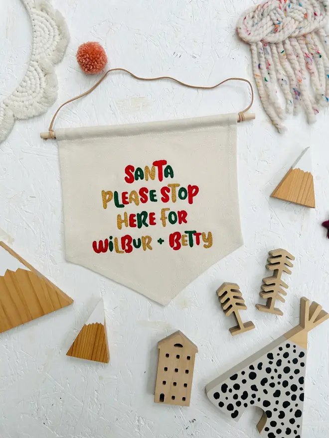personalised embroidered santa stop here banner. cotton banner embroidered with festive colours.
