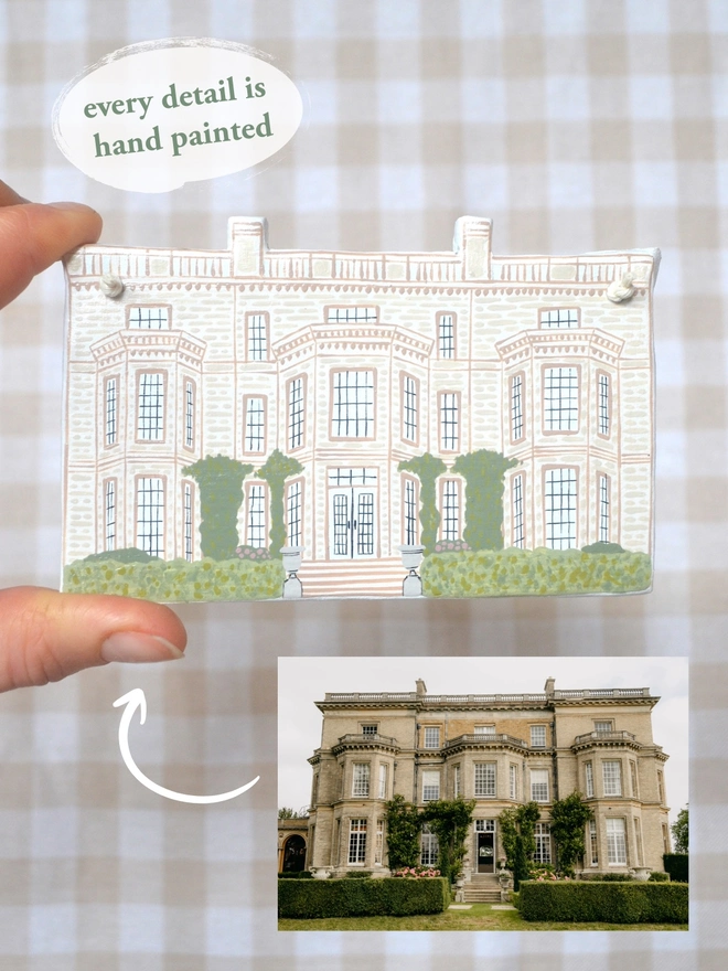 clay hanging design in the shape of a wedding venue with gingham background