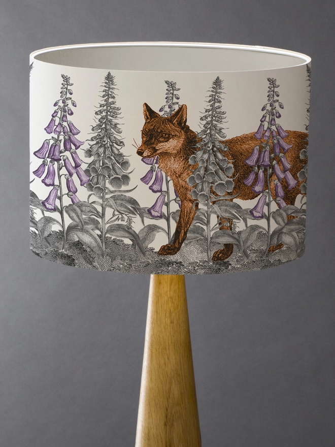 Handmade lampshade featuring a mischievous fox moving through foxglove flowers in a whimsical woodland design.