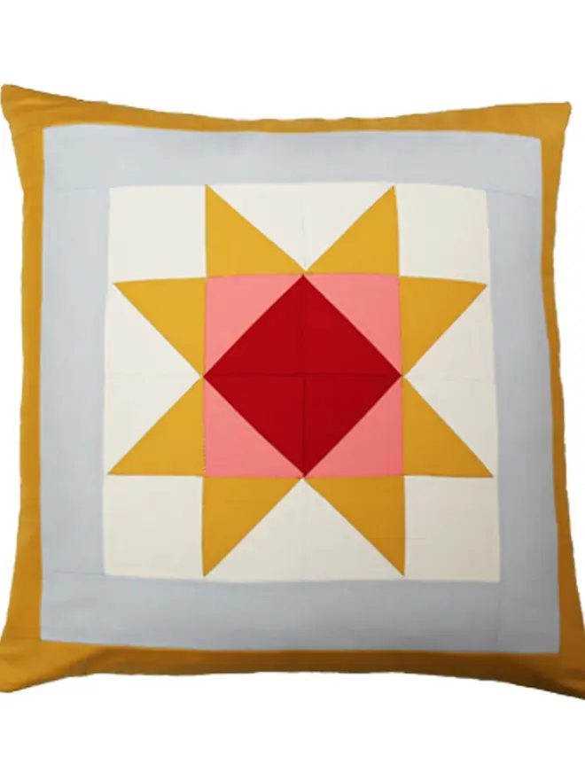 Warm Hearth Patchwork Cushion, against a white background. 